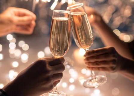 hands-young-couple-clinking-with-flutes-champagne-space-two-humans-holding-sparkling-bengal-lights